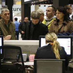 People gather at the airline information desk at of Russian airline Kogalymavias desk at Pulkovo airport in St.Petersburg, Russia, Saturday, Oct. 31, 2015, after a Russian airliner with 217 passengers and seven crew aboard crashed. Russia's civil air agency is expected to have a news conference shortly to talk about the Russian Metrojet passenger plane that Egyptian authorities say has crashed in Egypt's Sinai peninsula. (AP Photo/Dmitry Lovetsky)
