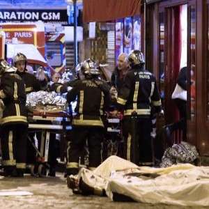 Rescue workers gather at victims in the 10th district of Paris, Friday, Nov. 13, 2015. Several dozen people were killed in a series of unprecedented attacks around Paris on Friday, French President Francois Hollande said, announcing that he was closing the country's borders and declaring a state of emergency. (AP Photo/Jacques Brinon)